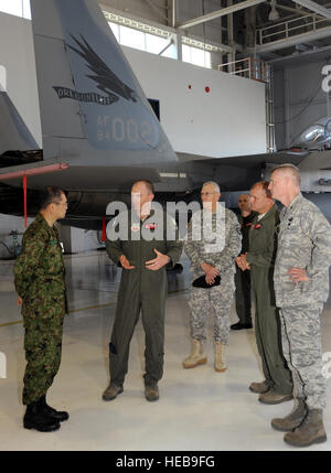 Oregon Air National Guard Lt. Col. Paul Fitzgerald, Aircraft Maintenance Commander for Oregon Air National Guard’s 142nd Fighter Wing describes the capabilities of the F-15 aircraft and mission with Maj. Gen. Mitsuru Nodomi, Japan’s Defense Attaché to the U.S. at the Portland Air National Guard Base, Portland, Ore., on May 18, 2011.  Nodomi is visiting the Oregon National Guard and touring facilities throughout the state. He expressed the gratitude of his nation for the friendship and support from neighbors across the Pacific. ( Tech. Sgt. John Hughel, 142nd FW Public Affairs) Stock Photo