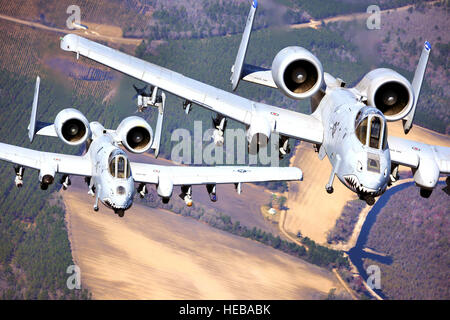 Two A-10C Thunderbolt II aircraft pilots fly in formation during a training exercise March 16, 2020, at Moody Air Force, Ga. Members of the 74th Fighter Squadron performed surge operations to push its support function to the limit and simulate pilots' wartime flying rates. Airman 1st Class Benjamin Wiseman) Stock Photo