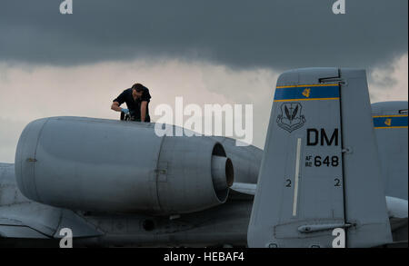 An aircraft maintainer assigned to the 354th Expeditionary Fighter Squadron inspects the oil levels of an A-10 Thunderbolt II attack aircraft engine during a theater security package deployment to Lask Air Base, Poland, July 13, 2015. The U.S. and Polish air forces will conduct training aimed at strengthening interoperability and demonstrating the countries' shared commitment to the security and stability of Europe.  Staff Sgt. Christopher Ruano Stock Photo