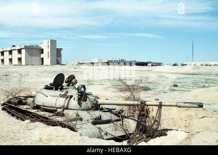 An Iraqi T-55 main battle tank lies abandoned near a field after the retreat of Iraqi forces from Kuwait during Operation Desert Storm. Stock Photo