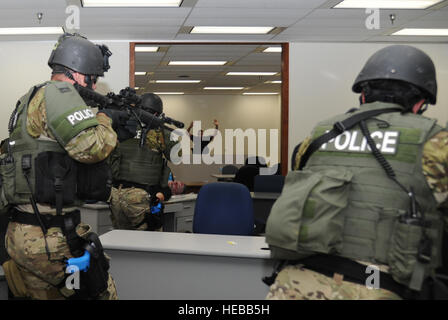 Special response team members assigned to the Biloxi Police Department apprehend a portrayed gunman during an active shooter exercise at Keesler Air Force Base, Miss., June 12, 2013. U.S. Airmen assigned to the 81st Security Forces Squadron invited the local law enforcement agency to participate in the exercise.  Kemberly Groue Stock Photo