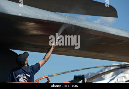 A fresh coat of gunship gray paint is sprayed onto the underside of the leading edge on the wing of the Rockwell B-1B Lancer nicknamed '7 Wishes,' (S/N 83-0070), at the Hill Aerospace Museum on April 29, 2015, by Envirotech Environmental Services of Stockbridge, Ga., employee Chris Pryor. Envirotech Environmental Services has been hired to paint several aircraft and other outdoor display items that are on public display at the museum. Alex R. Lloyd) Stock Photo
