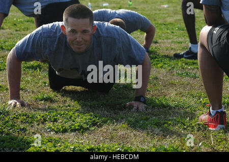 U.S. Army Staff Sgt. Dennis Botsch, 358th Transportation Detachment, 10th Trans. Battalion, 7th. Trans. Brigade (Expeditionary) transportation coordinator, performs push-ups during a group physical training portion of the Army Physical Readiness Training Leader Course at Fort Eustis, Va., April 22, 2014. The four-week course included hands-on training that incorporated basic military skills associated with PRT, such as marching, running, swimming, jumping, vaulting, climbing, carrying, lifting and load carrying. (U.S. Air Force photo by Senior Airman Teresa J.C. Aber/Released) Stock Photo