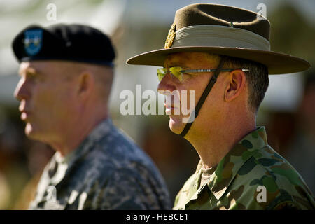 Maj. Gen. Roger F. Mathews, deputy commanding general U.S. Army, Pacific (USARPAC), and Australian Defense Force Maj. Gen. Richard M. Burr, Headquarters U.S. Army Pacific deputy commanding general of operations, sing 'The Army Song' during the conclusion of a Jan. 17, 2013, Deputy Commanding General Flying V Ceremony at the Historic Palm Circle on Fort Shafter, Honolulu, Hawaii. The ceremony held to welcome Burr and his family as the first foreign military officer to be assigned at this level of leadership in the U.S. Army. Burr's appointment as the USARPAC deputy commanding general of operati Stock Photo