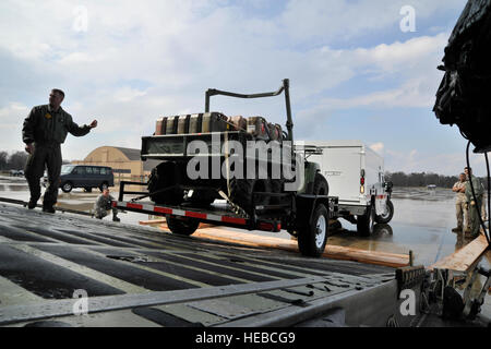 Marines from the II MArine Exeditionary Force, Chemical Biological Incident Response Force, Initial Response Force 'A' load CBIRF response vehicles onto a C-5 Galaxy, Apr. 1, 2011 at Joint Base Andrews, Md. The CBIRF is heading for Japan to provide the U.S. on-scene commander a rapid response capability and, if requested, [allow the commander to] assist the Japanese authorities by providing advice and expertise in the areas of agent detection and identification, casualty search and rescue, personnel decontamination and emergency medical care. This is CBIRF's first  overseas deployment since it Stock Photo