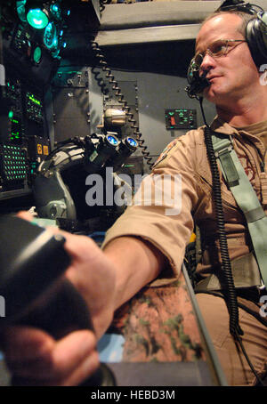Capt. Fred Phelan uses the joystick controls of the APN214 navigation system to designate waypoints on a display screen on Wednesday, April 19, 2006, over Southwest Asia. When the aircraft is in autopilot mode, it can fly itself to the series of waypoints regardless of weather or other flight factors. Captain Phelan is a Reserve navigator deployed to the 746th Expeditionary Airlift Squadron in support of Operation Iraqi Freedom. He is from the 327th Airlift Squadron at Willow Grove Air Reserve Station, Pa. (U.S. Air Force photo/Master Sgt. Lance Cheung) Stock Photo