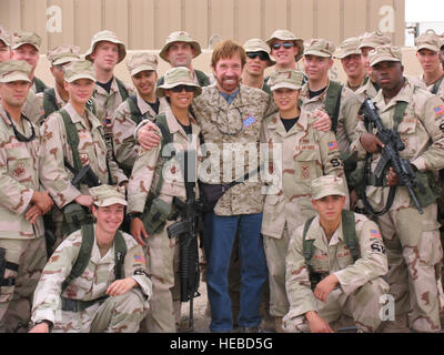 SOUTHWEST ASIA -- Actor Chuck Norris poses with members of the 386th Expeditionary Security Forces Squadron Oct. 29, 2006. Norris, who was accompanied by actor Marshall Teague, met with service members and signed autographs. An Air Force veteran, Norris is known around the world for his starring role on the TV hit “Walker, Texas Ranger.” He also has starred in more than 20 motion pictures, including“Delta Force,” “Missing in Action” and “Sidekicks.” The actor is also an accomplished author and renowned teacher of martial arts.   (AF photo/ Staff Sgt. Ian Carrier) Stock Photo