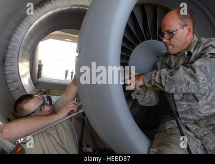 AL ASAD AIR BASE, Iraq -- Staff Sgt. Jonathan Pollack, 438th Air Expeditionary Group structural maintenance technician, (left) and Master Sgt. Anthony Bahur, structural maintenance supervisor, perform a structural repair on an A-10C Thunderbolt II's engine inlet here. The 438th AEG’s newly upgraded A-10C Thunderbolt IIs are the first to fly in combat. Sergeants Pollack and Bahur are deployed from the 175th Wing, Maryland Air National Guard, Baltimore. (U.S. Air Force photo/Tech. Sgt. D. Clare) Stock Photo
