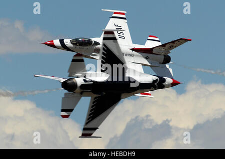 U.S. Air Force Maj's. Blaine Jones, Thunderbird 5, Lead Solo and Jason Curtis, Thunderbird 6, Opposing Solo, perform the Inverted Opposing Knife-Edge Pass during a practice show at the U.S. Air Force Academy, Colo., May 27, 2014. (U.S. Air Force photo/Staff Sgt. Larry E. Reid Jr., Released) Stock Photo