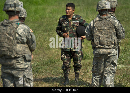 Philippine Army Capt. Heriberto Sangalang (center), 191st Military Police Battalion, teaches tactics and procedures used by Philippine Army Scout Rangers to U.S. service members during bilateral training at Balikatan 2012, April 19 at Clark Air Base, Philippines. The Philippines Army Scout Ranger program based its training regiment and its heritage back to the U.S. Sixth Army Special Reconnaissance Unit of World War II, known as the 'Alamo Scouts.' Balikatan is an annual training event aimed at improving combined planning, combat readiness, humanitarian assistance and interoperability between  Stock Photo