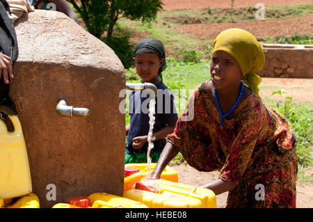 Local girls from Babile fill yellow water jugs for their families and communities at the area's main water source during a Veterinary Civic Action Program here May 26. Members of the U.S. Army 490th Civil Affairs Battalion, Combined Joint Task Force - Horn of Africa, participated in a VETCAP here May 21 - June 1 to help strengthen the capabilities of the community animal health workers, ensure livestock health, enhance agriculture and economic stability, and develop trust and confidence with this CJTF-HOA partner nation. Stock Photo