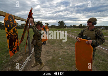 (Left) U.S. Marine Corps Cpl. Blake Cameron and Marine Sgt. Cody R. Nelson, both members of the III Marine Expeditionary Force shooting team, hang up cardboard targets prior international M9 pistol match at the 2012 Australian Army Skill at Arms Meeting May 9 in Puckapunyal, Australia. AASAM is an international marksmanship competition consisting of 16 different countries. This year is the fifth iteration of AASAM in Puckapunyal and the third consecutive year that U.S. forces have been invited to participate. In addition to being a marksman competition AASAM is a multilateral, multinational ev Stock Photo