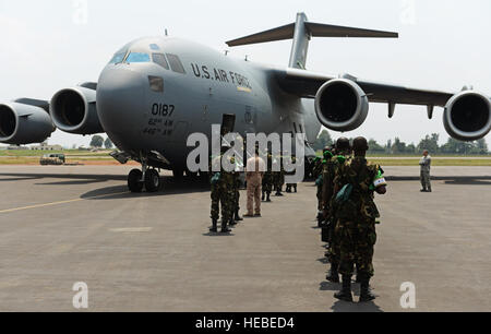 Rwandan soldiers wait in line at the Kigali airport to get on a C-17 Globemaster III based out of McChord Air Force Base, Wash., Jan. 19, 2014. U.S. forces will transport a total number of 850 Rwandan soldiers and more than 1,000 tons of equipment into the Central African Republic to aid French and African Union operations against militants during this three weeklong operation. (U.S. Air Force photo/ Staff Sgt. Ryan Crane) Stock Photo