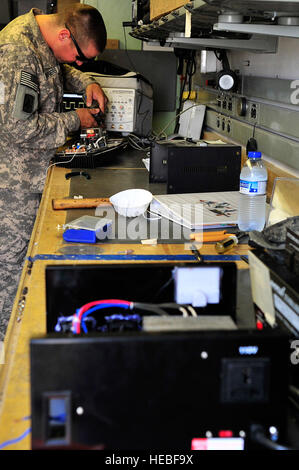 SOUTHWEST ASIA -- U.S. Army Pfc. John Howard, Headquarters and Headquarters Battery, 1st Battalion 7th Air Defense Artillery PATRIOT system repairer, fixes a public address system Jan. 31, 2013. Soldiers assigned to the 1-7 ADA are deployed to maintain the PATRIOT missile system and perfect their maintenance skills by repairing items such as game systems, controllers, televisions, cell phones, power converters, and single-portion coffee makers broken by other service members. (U.S. Air Force photo/Tech. Sgt. Christina M. Styer)(RELEASED) Stock Photo