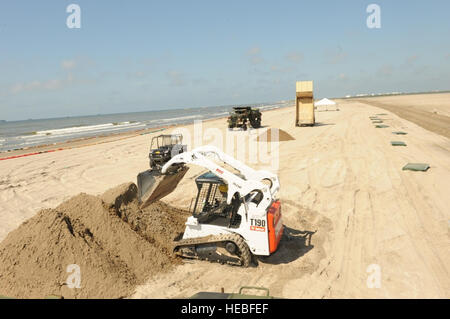 Soldiers of the Louisiana National Guard's 527th and 769th Engineer Battalions put together a wall of sand-filled Hesco Concertainer units in Port Fourchon, La., to help keep oil-tainted water from reaching Bay Champagne, May 21. Stock Photo