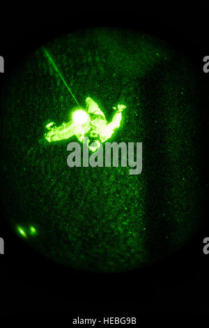 Pararescumen from the 82nd Expeditionary Rescue Squadron are lowered into the water from a CV-22 Osprey hovering above a simulated isolated personnel while conducting night hoist rescue operations as part of their requirement for upgrade training from CV-22 flown by the 20th Expeditionary Special Operations Squadron over the Gulf of Aden after taking off from Camp Lemonnier, Djibouti, July 1, 2015. The 82nd ERQS and the 20th ESOS are deployed in support of humanitarian aid and contingency operations in the Combined Joint Task Force Horn of Africa area of responsibility. (U.S. Air Force Photo b Stock Photo