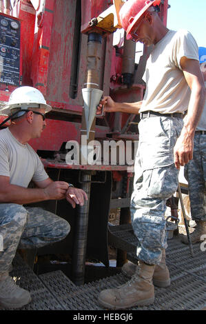 071222-F-6318R-328  CAMP LEMONIER, Djibouti -  Army Sgt. James A. Morgan (left) and Army Sgt. Bobby E. Keeling (right) test the viscosity of the mud used to drill a well on Camp Lemonier.  Keeling is a derrick hand for the 1132nd Engineering Detachment Well Drilling Team, and Morgan is an assistant well driller for the 1133rd Engineering Detachment Well Drilling Team. The 1132nd, which has been deployed to the Horn of Africa for more than a year, is training their sister unit to replace them. The Army National Guard well drillers are deployed from Mooresville, N.C.  U.S. Air Force photo by Sta Stock Photo