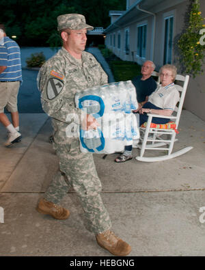 Sgt. 1st Class Wyatt G. Oscar, 1st/201st Field Artillery, West Virginia Army National Guard, helps unload bottled water at a nursing home in Lewisburg, W.Va. The WVNG was in the area to assist in providing relief for Greenbrier County due to a recent storm that caused power outages in the surrounding area. Stock Photo
