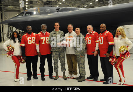 Kansas City Chiefs general manager John Dorsey presents Col. Matthew Brooks, 509th Bomb Wing vice commander, with a souvenir football at Whiteman Air Force Base, Mo., Nov. 18, 2014. The Chiefs annual visit is part of their community outreach program. (U.S. Air Force photo by Airman 1st Class Joel Pfiester/Released) Stock Photo