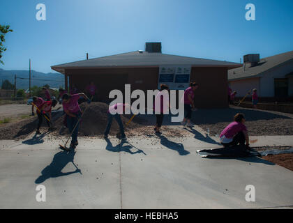 Volunteers for Habitat for Humanity work on landscaping at their construction site in downtown Alamogordo, N.M., May 9, 2015. The volunteers were participating in National Women Build Week, an annual event hosted by Habitat for Humanity where multiple volunteers devote their time to come together to help the members of the community who are less fortunate. (U.S. Air Force photo by Senior Airman Leah Ferrante/released) Stock Photo