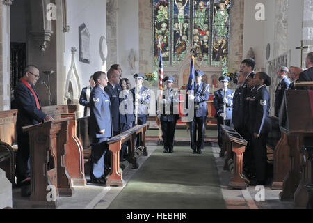 The 422nd Air Base Group Honor Guard presents the colors during the singing of the U.S. national anthem during a memorial service in the Parish Church of St. Mary Magdalene in Helmdon Nov. 2. The ceremony honored the 327th Bombardment Squadron, VIII Bomber Command, Airmen killed Nov. 30, 1943, when they left RAF Poddington on a bombing mission to Germany, and their plane crashed at Astwell Castle Farms. (U.S. Air Force photo by Staff Sgt. Brian Stives) Stock Photo