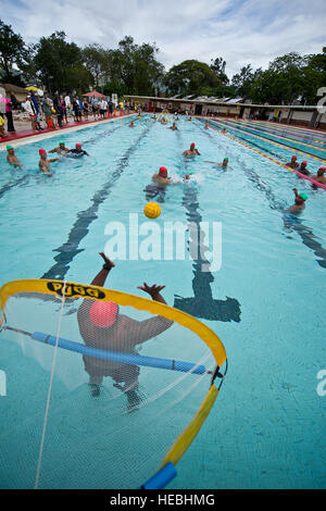 U.S. Army soldiers from Warrior Transition Battalion, Schofield Barracks Hawaii and U.S. Marines from Wounded Warrior Battalion-West Detachment Hawaii, Marine Corps Base Hawaii, Kaneohe Bay gathered for a friendly competition of water polo Sept. 7, 2012 at Richardson pool on Schofield Barracks. Standing water polo and innertube water polo are part of an adaptive sports program that offers wounded service members the opportunity to participate in physical training while having fun in a competitive environment. Stock Photo