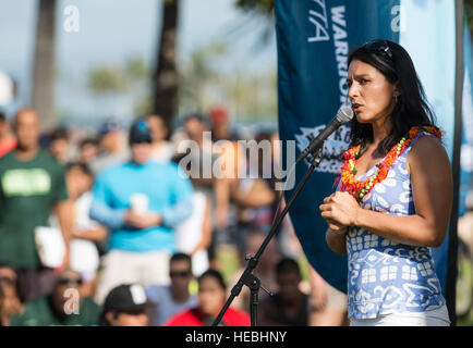 Hawaii Congresswoman Tulsi Gabbard, provides opening remarks during the Na Koa Wounded Warrior Canoe Regatta at the Fort DeRussy Beach Park Aug. 16, 2014, in Honolulu. The Wounded Warrior Canoe Regatta marks the events sixth anniversary. Twelve teams competed in the wounded warrior division, 33 teams competed in the military division for active duty, National Guard, Reserves and veterans and nine teams competed in the youth division. The Wounded Warrior Canoe Regatta was a part of the Duke's Oceanfest premier ocean sports festival. (U.S. Air Force photo by Staff Sgt. Christopher Hubenthal) Stock Photo