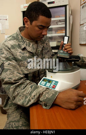 U.S. Air Force Staff Sgt. Anthony Orme, 380th Expeditionary Medical Group biomedical maintenance equipment technician, verifies the rotations per minute of a centrifuge at an undisclosed location in Southwest Asia Sept. 25, 2013. Orme maintains all medical equipment in the 380th EMDG. Orme is native to Weirton, W.Va., and is deployed from Tyndall Air Force Base, Fla. (U.S. Air Force photo by Staff Sgt. Joshua J. Garcia) Stock Photo