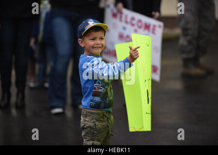 A young boy waits for his father to return from a six-month rotational deployment to Southwest Asia, to Spangdahlem Air Base, Germany, Oct. 20, 2016. Nearly 200 Airmen assigned to the 606th Air Control Squadron returned after providing support to the 727th Expeditionary Air Control Squadron, also known as Kingpin, which is composed of U.S. and coalition partners who monitor activity in the airspace surrounding their area of responsibility. (U.S. Air Force photo by Senior Airman Joshua R. M. Dewberry) Stock Photo