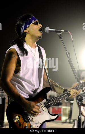 JoJo, bass guitar player for the Grammy Award winning Rock-N-Roll trio Los  Lonely Boys, grimaces as he plays during a music concert featuring the  Texas based band, at Contingency Operating Base Speicher