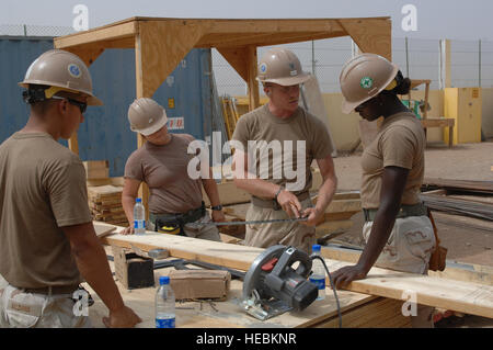 Builders Mate second class Patrick Tansey mentors fellow Sea Bees assigned to Naval Mobile Construction Battalion Eleven (NMCB11), Gulfport, Mississippi, during a project at Douda Primary School on July 17, 2009. NMCB 11 is attached to the Combined Joint Task Force-Horn of Africa (CJTF-HOA) and began building this cantina at the school in March of 2009 and have put in over 13,608 manhours in temperatures well above 100 degrees. The service members of CJTF-HOA, headquartered in Djibouti, employ an indirect approach to counter violent extremism. Through a strategy of cooperative conflict prevent Stock Photo