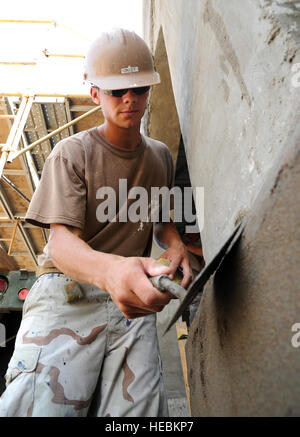 U.S. Navy Petty Officer 3rd Class Brian Casey, a Seabee assigned to Naval Mobile Construction Battalion 74, Detail Horn of Africa, uses a trowel to apply and smooth a coat of stucco to an exterior wall during construction at the Ecole 5 primary school construction project, Feb. 18.  NMCB 74, Det. HOA is deployed to support Combined Joint Task Force-Horn of Africa by providing construction engineering support of schools, medical clinics and water wells throughout the region. The unit’s commodore, Navy Capt. Kathryn Donovan, visited the site, Feb. 18. (U.S. Air Force photo by Master Sgt. Dawn M. Stock Photo