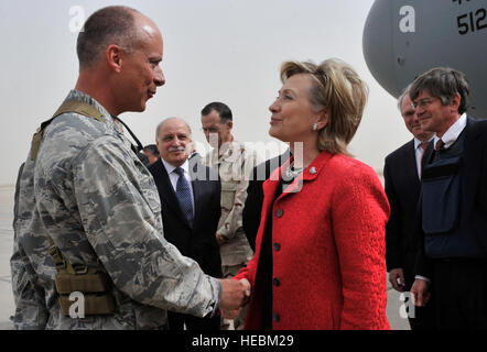Col. Jon Andre, 447th Air Expeditionary Group commander, greets Secretary of State Hillary Clinton on the flightline, April 25. Clinton passed through Sather during an unannounced visit to Baghdad, Iraq, to meet with U.S. military leaders and top Iraqi government officials. She also met with U.S. service members and Iraqi civilians during a town hall meeting at the U.S. Embassy in Iraq. Stock Photo