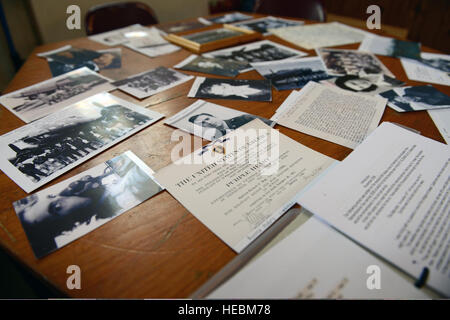 Photos and documents belonging to the crew of the Sharon Belle, a U.S. Air Force B-17 Flying Fortress aircraft, sit on a table during a memorial service at the Church of St. Mary Magdalene in Helmdon, England, Nov. 2, 2013. Airmen assigned to the 422nd Air Base Group attended the ceremony honoring the 10 Airmen assigned to the 327th Bombardment Squadron who were killed when the aircraft crashed at Astwell Castle Farms during a bombing mission Nov. 30, 1943. (U.S. Air Force photo by Tech. Sgt. Chrissy Best/Released) Stock Photo