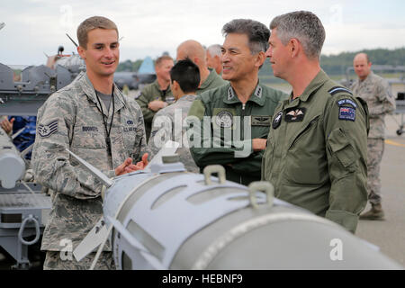 U.S. Air Force Staff Sgt. Jerry Boomers, left, assigned to the 3rd Maintenance Group, interacts with Japan Air Self Defense Force Lt. Gen. Hiroaki Maehara, center, the vice commander of Air Defense Command, and Royal New Zealand Air Force Air Commodore Darryn Webb, air component commander, during a static display presentation for RED FLAG-Alaska (RF-A) 16-2, Executive Observer Program at Joint Base Elmendorf-Richardson, Alaska, June 10, 2016. Senior air leaders, from Bangladesh, Canada, Finland, Germany, Indonesia, Japan, Mongolia, New Zealand, the Philippines, Sri Lanka, Sweden, Thailand and  Stock Photo