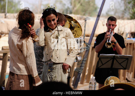 Iraqi girls dance as they enjoy music from the band during the Community Service Project for the Tikrit Orphanage hosted by U.S. Soldiers from 25th Special Troops Battalion, 25th Infantry Division, on Contingency Operating Base Speicher, Iraq, Sept. 23. The event was to set an example of community service and show commitment to those affected by the violence in Iraq. Stock Photo