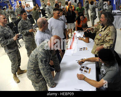 Military and civilian personnel line up to get autographs from the actors of the Sons of Anarchy at a meet and greet event at Joint Base Balad, Iraq, March 15, 2010. Four cast members from the hit television show are touring bases throughout Southwest Asia to show their appreciation and provide a morale boost for deployed personnel. (U.S. Air Force photo by Master Sgt. Linda C. Miller/Released) Stock Photo