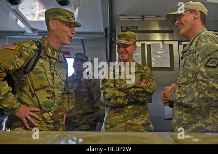 COATEPEQUE, Guatemala – From left to right, U.S. Army Reserve Brig. Gen. James Mason, 807th Medical Command deputy commanding general, and U.S. Army Lt. Gen. Joseph DiSalvo, U.S. Southern Command military deputy commander, speak with Arkansas National Guard Spc. Colton Jones, 224th Maintenance Company food specialist, during a visit May 17, 2016, during Exercise BEYOND THE HORIZON 2016 GUATEMALA. Mason and DiSalvo spoke with Jones about the food service capabilities during the exercise. (U.S. Air Force photo by Senior Airman Dillon Davis/Released) Stock Photo