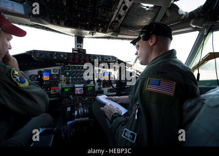 Pennsylvania Air National Guard Airmen Lt. Col. Chuck Tubbs, aircraft commander, left, and 1st. Lt Brandon Rader, right, both of the 171st Air Refueling Wing, accomplish their pre-flight checklist prior to launch of a KC-135 Stratotanker from the Combat Readiness Training Center (CRTC) flight line in Gulfport, Miss., during Exercise Southern Strike 15 (SS15), Oct. 28, 2014. SS15 is a total force, multiservice training exercise hosted by the Mississippi National Guard's CRTC from Oct. 27 through Nov. 7, 2014. The SS15 exercise emphasizes air-to-air, air-to-ground and special operations forces t Stock Photo