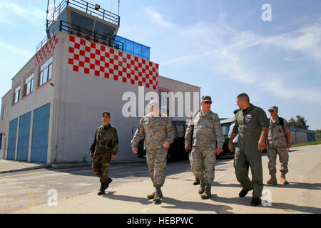 Albanian Air Force Col. Frederik Beltoja, second from right, Farke Air Base commander, discusses the improvements the base is undergoing in front of the recently completed control tower and fire station with, left to right Albanian Armed Forces Command Sgt. Maj. Proletar Panxha, New Jersey State Command Chief Master Sgt. Michael Francis and Lt. Col. Richard Reitberger, both assigned to Joint Force Headquarters ? New Jersey and 177th Fighter Wing Fire Chief Master Sgt. Anthony Boccelli, right, on Sept. 21, 2010. Members of the New Jersey Air National Guard visited the Republic of Albania to dis Stock Photo