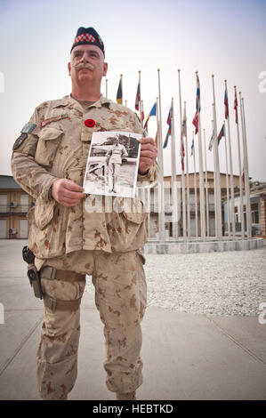 Canadian army Master Warrant Officer Rick Ostashower holds a photograph of his father outside the NATO Training Mission-Afghanistan headquarters building in Kabul. In Canada, Remembrance Day is a holiday observed, Nov. 11, of each year in remembrance of those who died in World Wars I and II and subsequent conflicts. Stock Photo