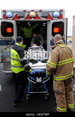 Senior Airman Derek Asbury, 509th Maintenance Group, is transported into the back of an ambulance during an active-shooter exercise at Whiteman Air Force Base, Mo., Feb. 11, 2015.  The Johnson County Ambulance District, from Warrensburg, Mo., also participated as local-civilian first responders during the exercise. (U.S. Air Force photo by Airman 1st Class Joel Pfiester/Released) Stock Photo