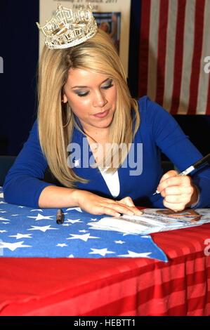 Ms. Teresa Scanlan, Miss America 2011, signs photographs at Lagnely Air Force Base, Va., March 21, 2011. Miss Scanlan dreams of becoming an attorney and eventually a judge or the President of the United States of America. (U.S. Air Force photo by Airman 1st Class Racheal Watson/Released) Stock Photo