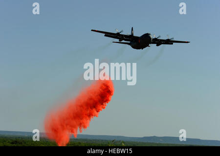 A C-130H Hercules from the 302nd Airlift Wing, Colorado Springs Air Force Reserve, drops fire retardant near Abilene Regional Airport, Abilene, Texas, May 5, 2011.  The C-130 is equipped with the Modular Airborne Firefighting System (MAFFS) which is capable of dispensing 3,000 gallons of water or fire retardant in under 5 seconds.  Wildfires have spread across various parts of Texas and have burned more than 1.5 million acres since January.  (U.S. Air Force Photo/Staff Sgt. Eric Harris) Stock Photo