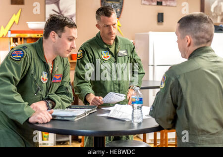 U.S. Air Force Capt. Julian T. Spoelstra, left, of the 389th Fighter Squadron based at Mountain Home Air Force Base, Idaho, and U.S. Marine Corps Maj. Joseph F. Freshour, conduct a test flight debriefing with U.S. Air Force Maj. Christopher White, the 59th Test and Evaluation Squadron F-35 project manager, at Mountain Home AFB, Idaho, February 17, 2016. Six operational test and evaluation F-35s and more than 85 Airmen of the 31st TES, traveled to Mountain Home AFB to conduct the first simulated deployment test of the F-35A, specifically to execute three key initial operational capability missi Stock Photo