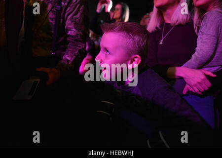 A boy in the audience watches the USO Spring 2016 Entertainment Tour featuring Miss America Betty Cantrell, country singer and 10-year Army veteran Craig Morgan, North Carolina Panthers football player Charles Tillman, and Ultimate Fighting Championship fighters Anthony Pettis and Donald 'Cowboy' Cerrone at Joint Base Elmendorf-Richardson March 12. The tour was led by Air Force Gen. Paul Selva, 10th Vice Chairman of the Joint Chiefs of Staffs, who used this as an opportunity to visit Arctic Warriors. (U.S. Air Force photo by Airman 1st Class Kyle Johnson) Stock Photo