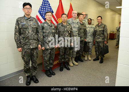 Fourth from left, U.S. Army Brig. Gen. John P. Sullivan, U.S. Army Transportation Corps chief of transportation, hosted Republic of Korea Transportation Command commander, Brig. Gen. Jong Goo Lee, third from left, at the Simulation Center at Fort Eustis, Va., May 13, 2014. Lee and his team of transportation officers had the opportunity to test a few of the center’s training simulators during their tour of the Transportation Corps Maritime Training capabilities. (U.S. Air Force photo by Airman 1st Class Kimberly Nagle/Released)(Photo was cropped, color corrected and sharpened.) Stock Photo