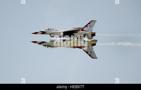 Maj's. Blaine Jones, Thunderbird 5, lead solo, and Jason Curtis, Thunderbird 6, opposing solo, perform one of their trademark maneuvers, the Reflection Pass, during the Star Spangled Salute Air Show at Tinker Air Force Base, Okla., June 22, 2014. (U.S. Air Force photo/Master Sgt. Stan Parker) Stock Photo