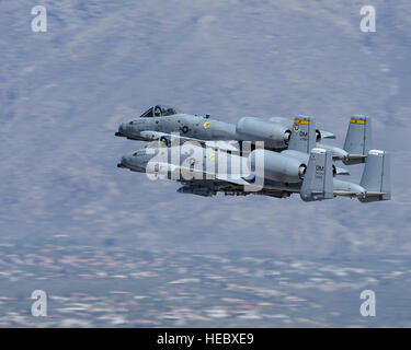 Two A-10C Thunderbolt IIs fly in tandem during a demonstration at the Thunder and Lightning over Arizona Open House at Davis-Monthan Air Force Base, Ariz., March 12, 2016. The Desert Lightning Team demonstration included A-10 Thunderbolt IIs, HH-60G Pave Hawks and an HC-130J Combat King. (U.S. Air Force photo by Senior Airman Chris Massey/Released) Stock Photo