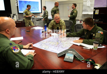 Sqn Ldr Gordon Ferguson from UK and LCL Pascal Sotty from France, plan the tri-lateral exercise, Tonnerre Lightning, with U.S. Air Force pilots and 603rd Air and Space Operations Center planning teams on March 27, 2014 at Ramstein Air Base, Germany. The exercise is the first in a series of semi-annual exercises between the NATO countries to improve interoperability and communication in the event of a real-world scenario. This first exercise was conducted off of the English coast and focused on strengthening communication between all agencies involved. (U.S. Air Force photo/Staff Sgt. Ryan Cran Stock Photo